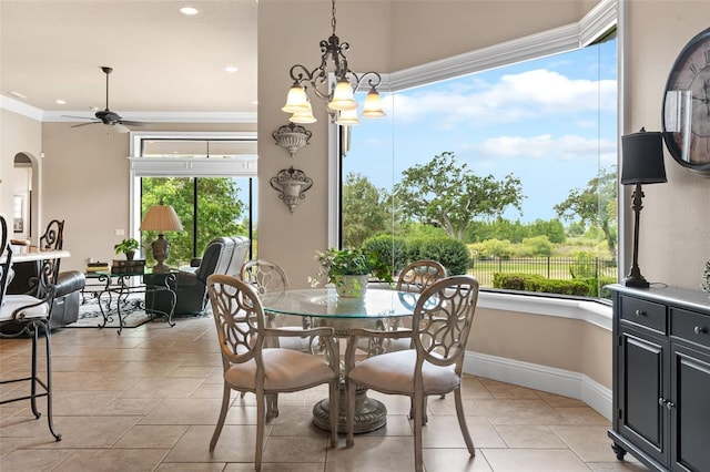 dining space featuring light tile patterned floors, a ceiling fan, crown molding, and plenty of natural light