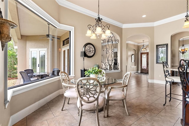 tiled dining area with baseboards, arched walkways, ceiling fan with notable chandelier, and crown molding