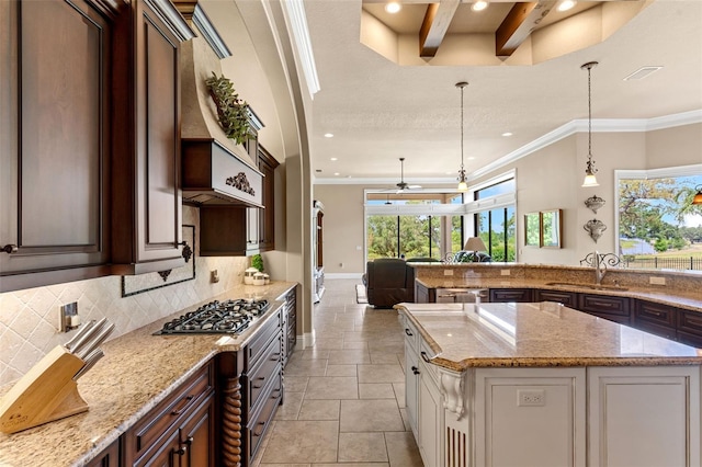 kitchen featuring stainless steel gas cooktop, recessed lighting, backsplash, ornamental molding, and open floor plan
