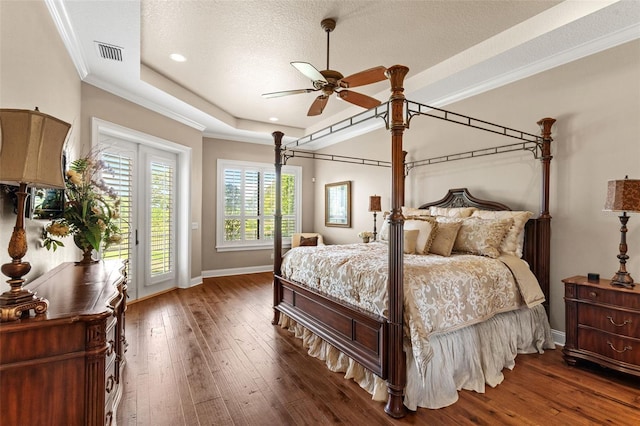 bedroom featuring baseboards, visible vents, access to exterior, and hardwood / wood-style floors