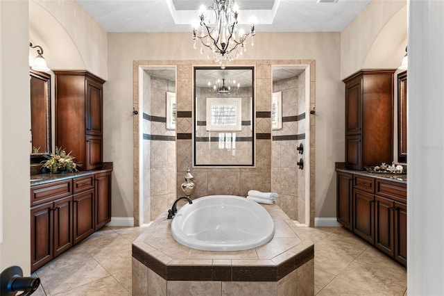 full bathroom with baseboards, an inviting chandelier, a bath, a walk in shower, and vanity