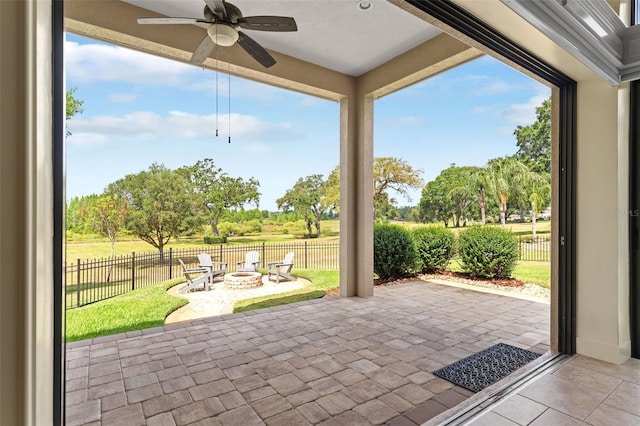 view of patio / terrace featuring a fire pit, ceiling fan, and a fenced backyard