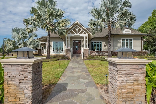view of front of house featuring a porch and a front lawn