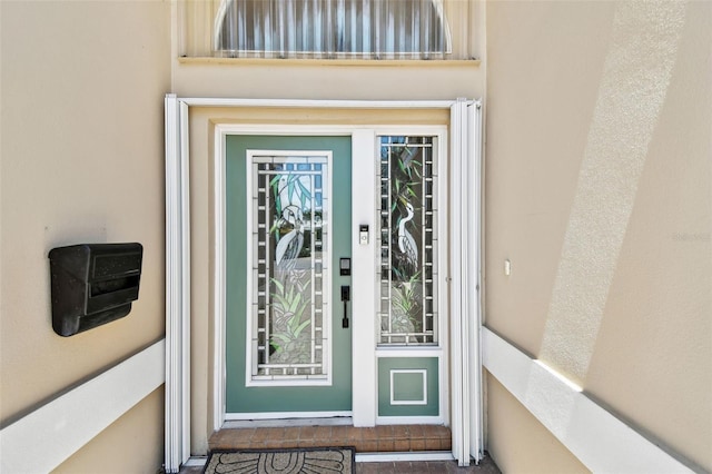 17 Bellevue Dr, Treasure Island, FL 33706 - doorway to property featuring stucco siding
