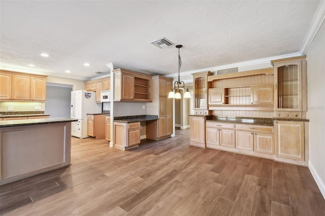 17 Bellevue Dr, Treasure Island, FL 33706 - kitchen with open shelves, crown molding, wood finished floors, white appliances, and recessed lighting