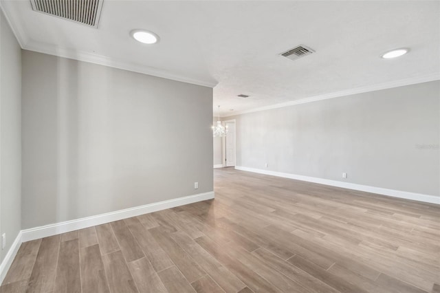 17 Bellevue Dr, Treasure Island, FL 33706 - unfurnished room with a chandelier, wood finished floors, ornamental molding, baseboards, and recessed lighting