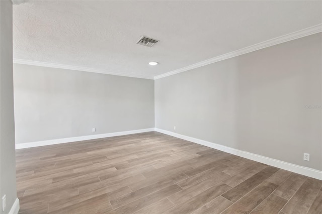 17 Bellevue Dr, Treasure Island, FL 33706 - unfurnished room with wood finished floors, baseboards, crown molding, and recessed lighting