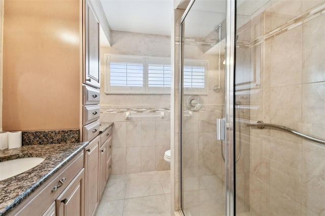 17 Bellevue Dr, Treasure Island, FL 33706 - bathroom with vanity, a shower stall, toilet, and tile patterned floors