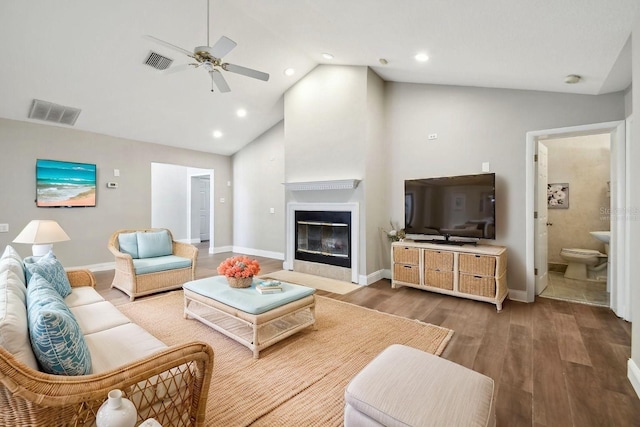 17 Bellevue Dr, Treasure Island, FL 33706 - living area with ceiling fan, wood finished floors, baseboards, high vaulted ceiling, and a fireplace with flush hearth