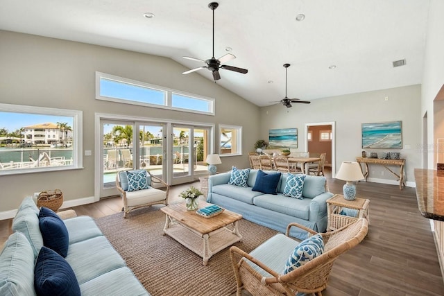 17 Bellevue Dr, Treasure Island, FL 33706 - living room with a ceiling fan, wood finished floors, high vaulted ceiling, and baseboards