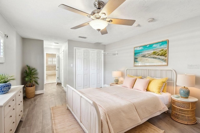 17 Bellevue Dr, Treasure Island, FL 33706 - bedroom featuring wood finished floors, a closet, a ceiling fan, and baseboards