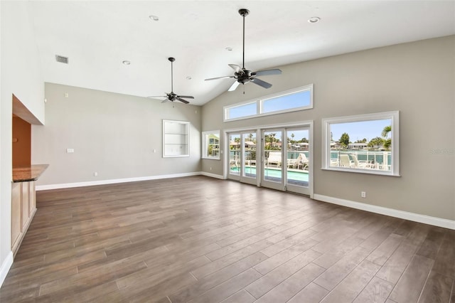 17 Bellevue Dr, Treasure Island, FL 33706 - unfurnished living room with ceiling fan, dark wood-style flooring, high vaulted ceiling, and baseboards