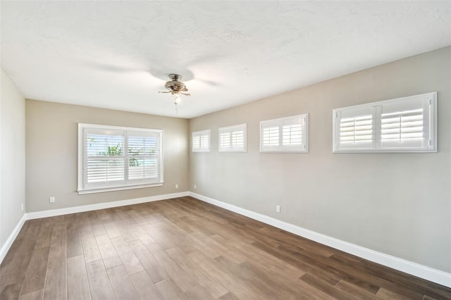 17 Bellevue Dr, Treasure Island, FL 33706 - unfurnished room with ceiling fan, baseboards, and dark wood finished floors