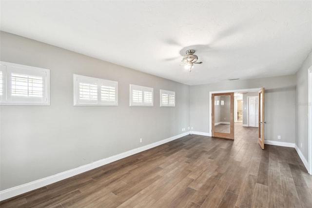 17 Bellevue Dr, Treasure Island, FL 33706 - spare room with baseboards, a ceiling fan, french doors, and dark wood finished floors