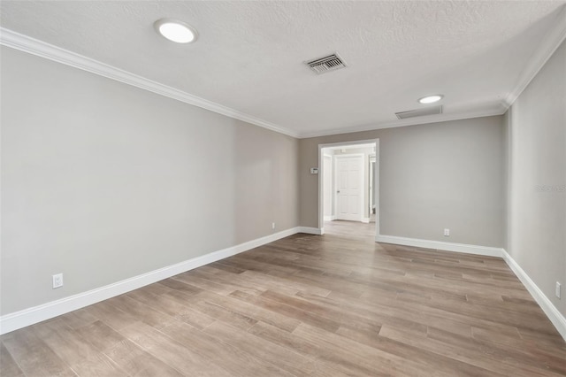 17 Bellevue Dr, Treasure Island, FL 33706 - spare room with light wood-style flooring, baseboards, crown molding, and a textured ceiling