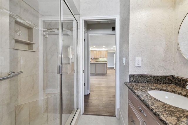 17 Bellevue Dr, Treasure Island, FL 33706 - bathroom with a stall shower, vanity, and a textured wall