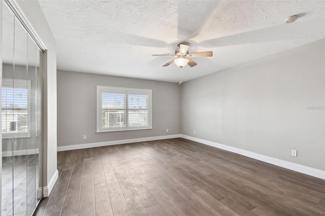 17 Bellevue Dr, Treasure Island, FL 33706 - empty room featuring ceiling fan, dark wood-style flooring, baseboards, a textured ceiling, and a smoke detector