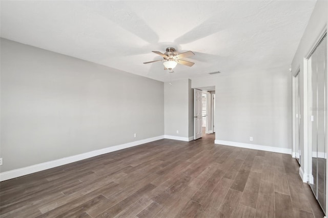 17 Bellevue Dr, Treasure Island, FL 33706 - unfurnished room with a ceiling fan, dark wood-style floors, and baseboards