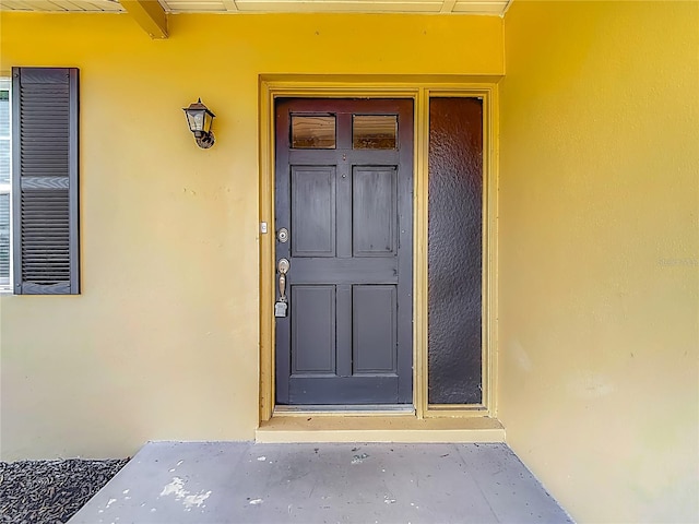 7280 Tarrytown Dr, Spring Hill, FL 34606 - doorway to property with stucco siding