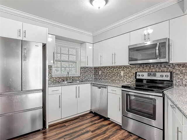 7280 Tarrytown Dr, Spring Hill, FL 34606 - kitchen with a sink, stainless steel appliances, crown molding, backsplash, and white cabinets