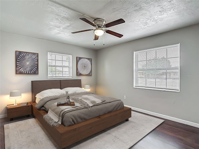 7280 Tarrytown Dr, Spring Hill, FL 34606 - bedroom with baseboards, wood finished floors, and ceiling fan