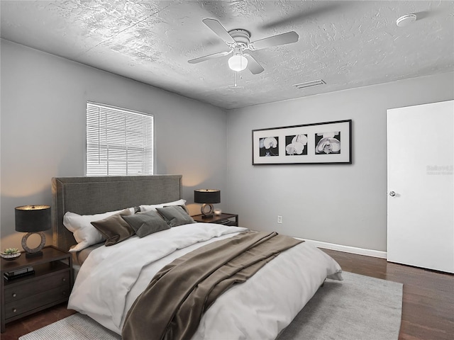 7280 Tarrytown Dr, Spring Hill, FL 34606 - bedroom with a textured ceiling, visible vents, ceiling fan, baseboards, and wood finished floors