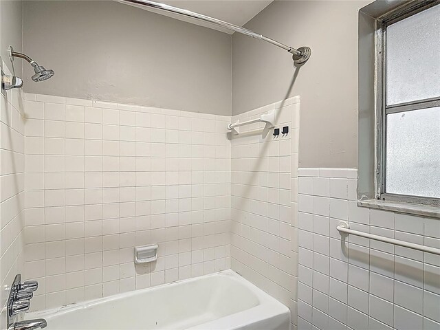 7280 Tarrytown Dr, Spring Hill, FL 34606 - bathroom with tile walls, a wainscoted wall, and shower / bathtub combination