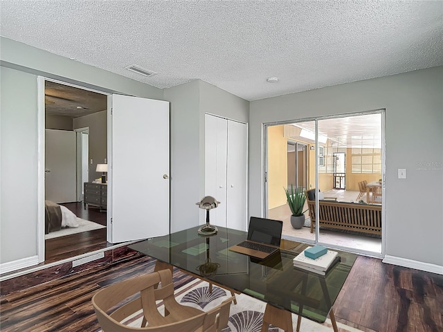 7280 Tarrytown Dr, Spring Hill, FL 34606 - home office with a textured ceiling, wood finished floors, visible vents, and baseboards