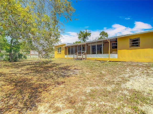 7280 Tarrytown Dr, Spring Hill, FL 34606 - back of house featuring fence and a sunroom