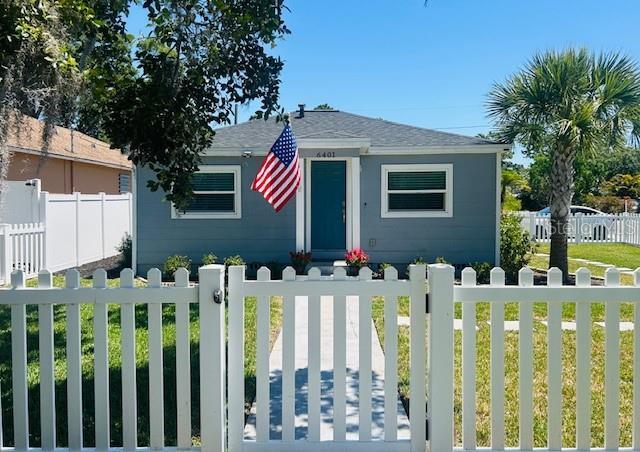 6401 30th Way N, Saint Petersburg, FL 33702 - bungalow with roof with shingles, a front yard, and a fenced front yard