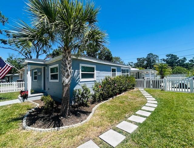 6401 30th Way N, Saint Petersburg, FL 33702 - view of front of house featuring a front lawn and fence