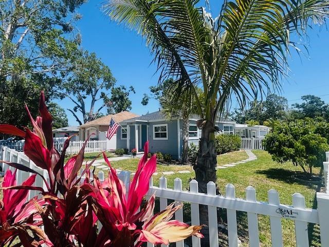 6401 30th Way N, Saint Petersburg, FL 33702 - view of front of house featuring a front lawn and fence private yard