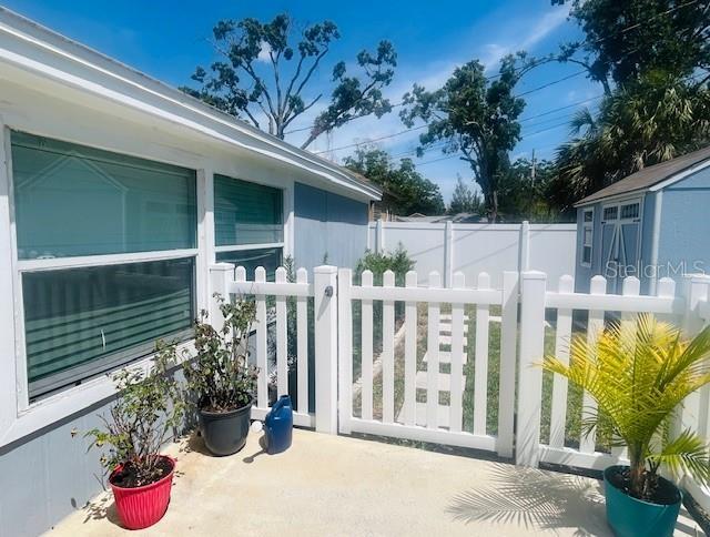 6401 30th Way N, Saint Petersburg, FL 33702 - exterior space featuring a storage shed, fence private yard, and an outdoor structure