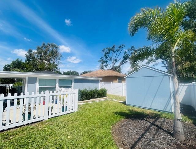 6401 30th Way N, Saint Petersburg, FL 33702 - view of yard with an outdoor structure, fence private yard, and a shed