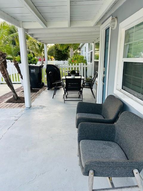 6401 30th Way N, Saint Petersburg, FL 33702 - view of patio / terrace featuring fence and outdoor dining space