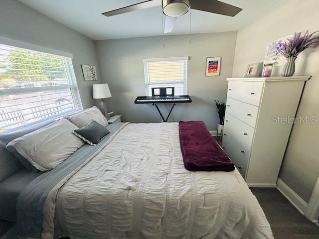 6401 30th Way N, Saint Petersburg, FL 33702 - bedroom featuring dark wood finished floors, baseboards, and ceiling fan