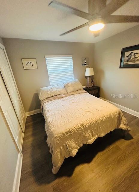 6401 30th Way N, Saint Petersburg, FL 33702 - bedroom featuring ceiling fan, baseboards, and dark wood-style flooring