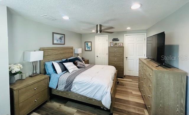 6401 30th Way N, Saint Petersburg, FL 33702 - bedroom featuring recessed lighting, wood finished floors, visible vents, a ceiling fan, and a textured ceiling