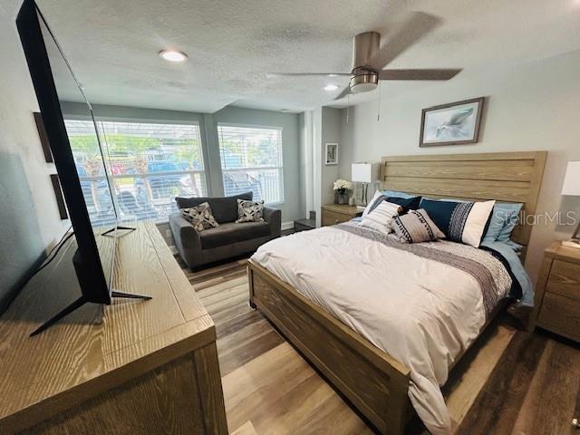 6401 30th Way N, Saint Petersburg, FL 33702 - bedroom featuring ceiling fan, wood finished floors, and a textured ceiling