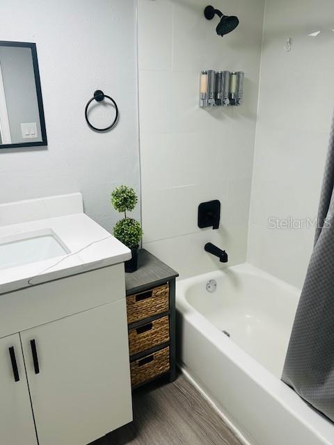 6401 30th Way N, Saint Petersburg, FL 33702 - bathroom with wood finished floors, vanity, and shower / bath combination with curtain