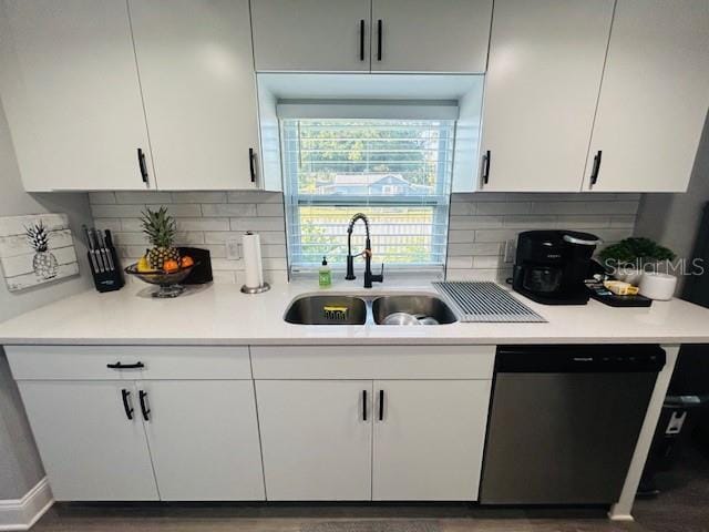 6401 30th Way N, Saint Petersburg, FL 33702 - kitchen with stainless steel dishwasher, light countertops, a sink, and white cabinetry