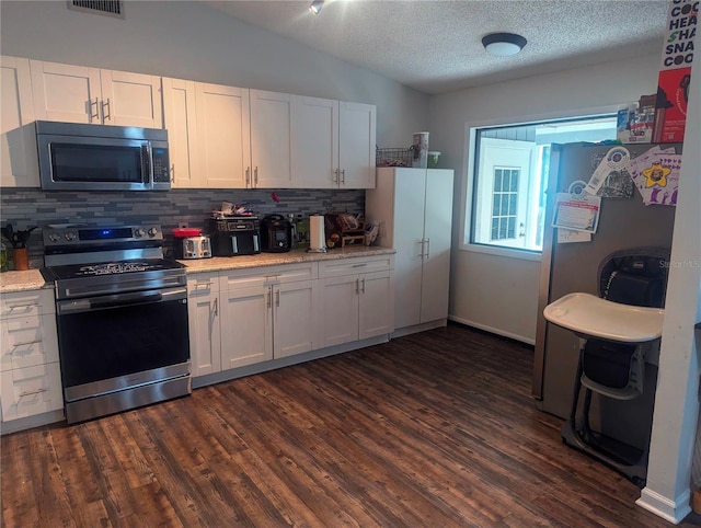 37654 Eiland Blvd, Zephyrhills, FL 33542 - kitchen with stainless steel appliances, backsplash, light countertops, and vaulted ceiling