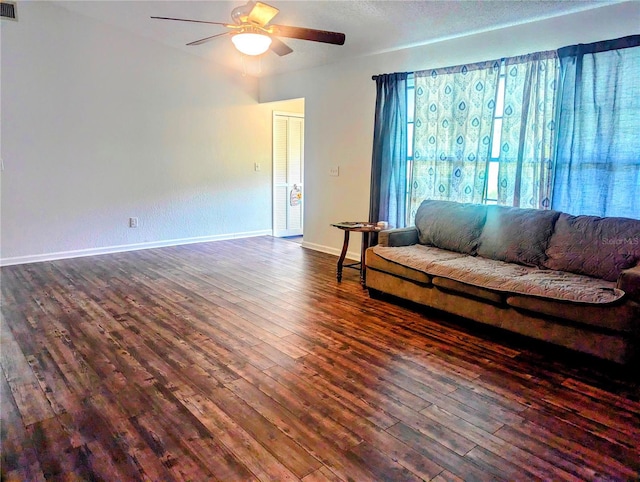37654 Eiland Blvd, Zephyrhills, FL 33542 - living area with baseboards, visible vents, ceiling fan, and dark wood-style flooring
