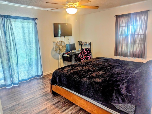 37654 Eiland Blvd, Zephyrhills, FL 33542 - bedroom featuring baseboards, wood finished floors, and a ceiling fan