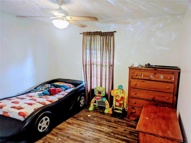 37654 Eiland Blvd, Zephyrhills, FL 33542 - bedroom with a ceiling fan, wood finished floors, and a textured ceiling