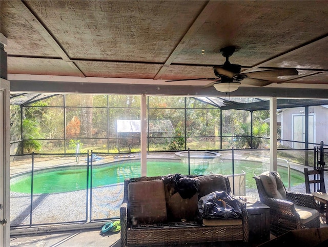 37654 Eiland Blvd, Zephyrhills, FL 33542 - sunroom featuring a jacuzzi, a healthy amount of sunlight, and a ceiling fan