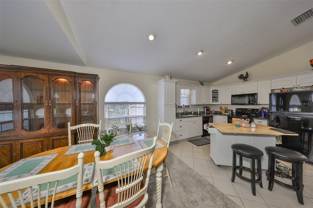 dining room with light tile patterned floors, recessed lighting, visible vents, and vaulted ceiling