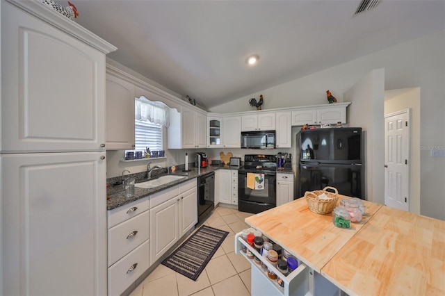 kitchen featuring white cabinets, a sink, visible vents, black appliances, and light tile patterned flooring