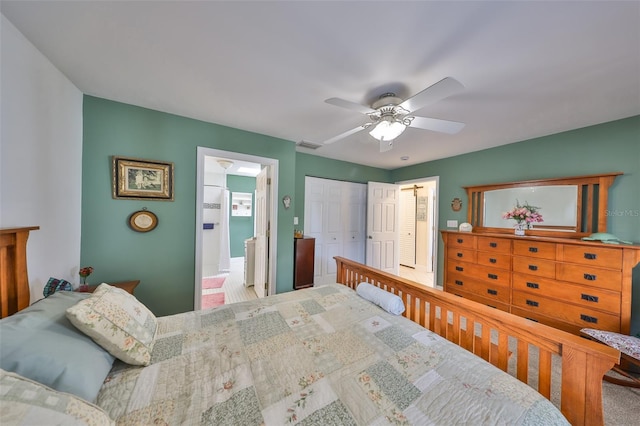 carpeted bedroom featuring visible vents, ceiling fan, connected bathroom, and a closet