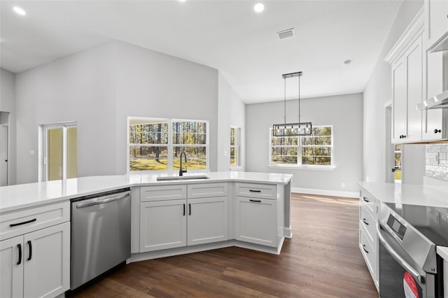 kitchen with visible vents, dark wood-type flooring, light countertops, a sink, and appliances with stainless steel finishes